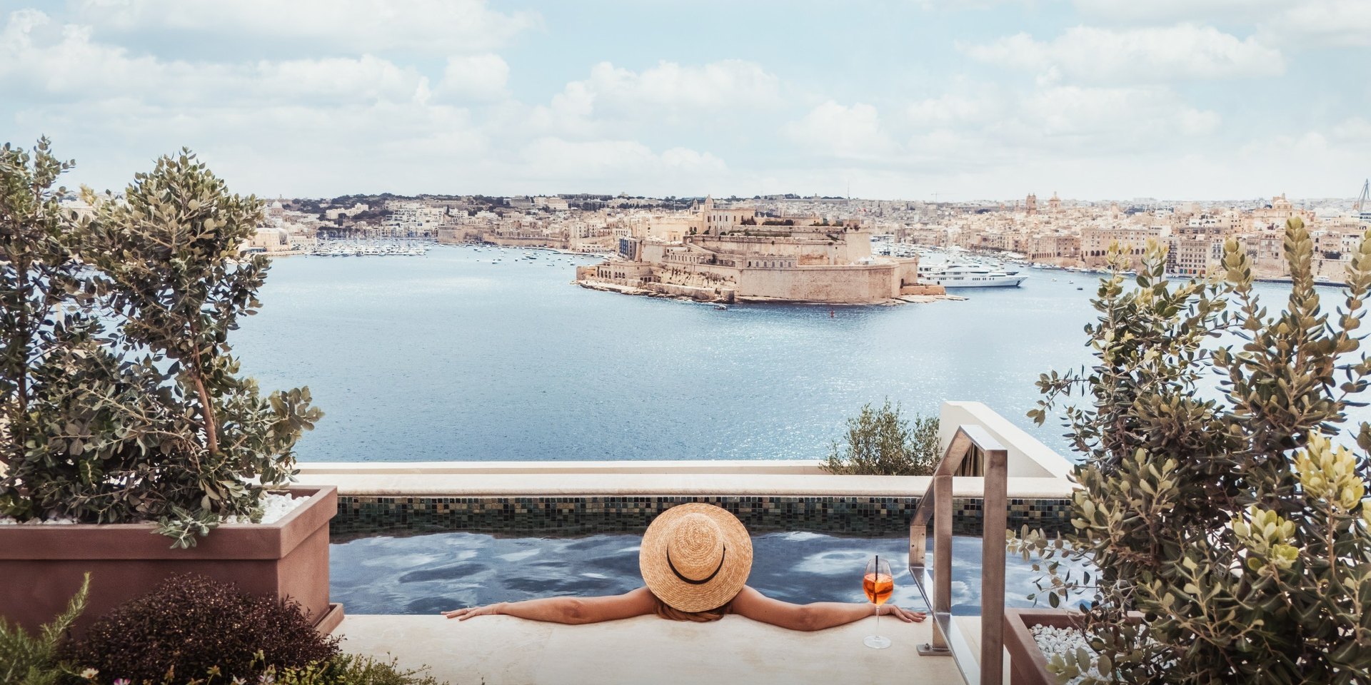 The rooftop pool at Iniala Harbour House, looking across the Grand Harbour to Fort St Angelo